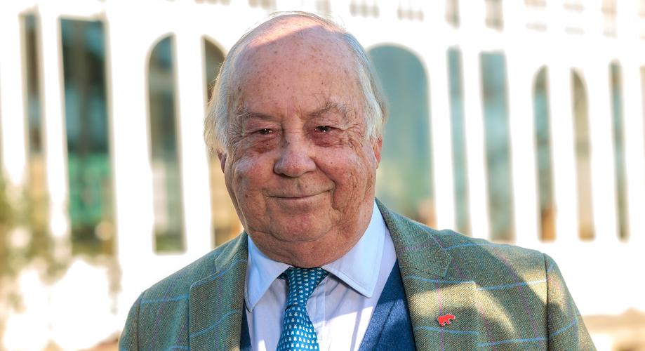 A head and shoulder portrait of an adult male in a suit