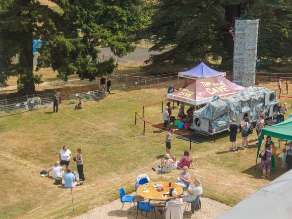 An aerial view of a climbing wall, tents, tables and sheep at the Mary Hare Family Fun Day 2025
