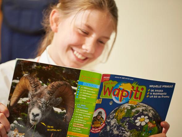 A pupil is reading a French book.