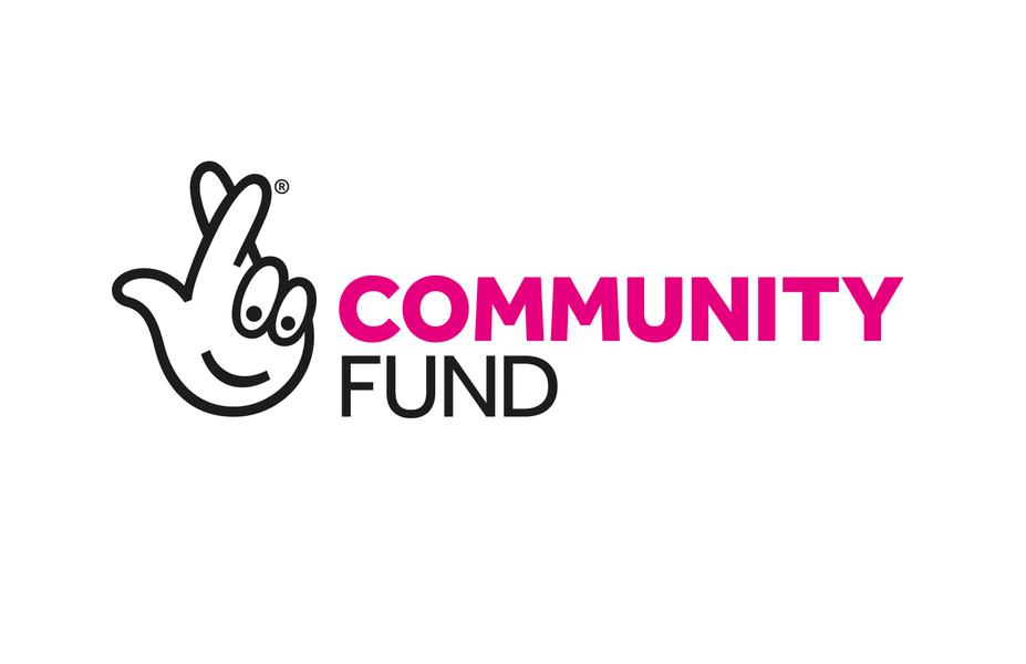 A hand with its fingers crossed and next to it the words in pink and black 'community fund'
