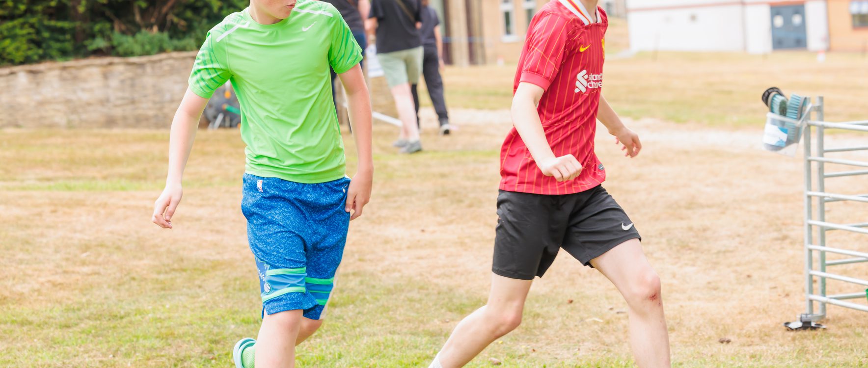 Two boys having a kick about with a football
