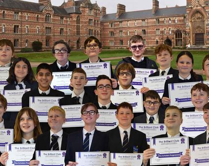 A group of students holding certificates, superimposed onto a University background