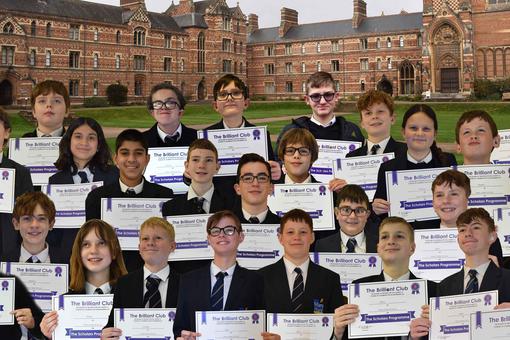 A group of students holding certificates, superimposed onto a University background