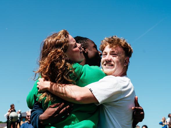 A group of students hugging each other
