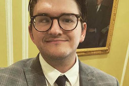 A head and shoulder of a male who is wearing his medal.