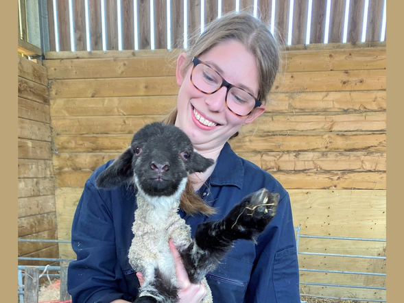 Neve Massey holding a lamb
